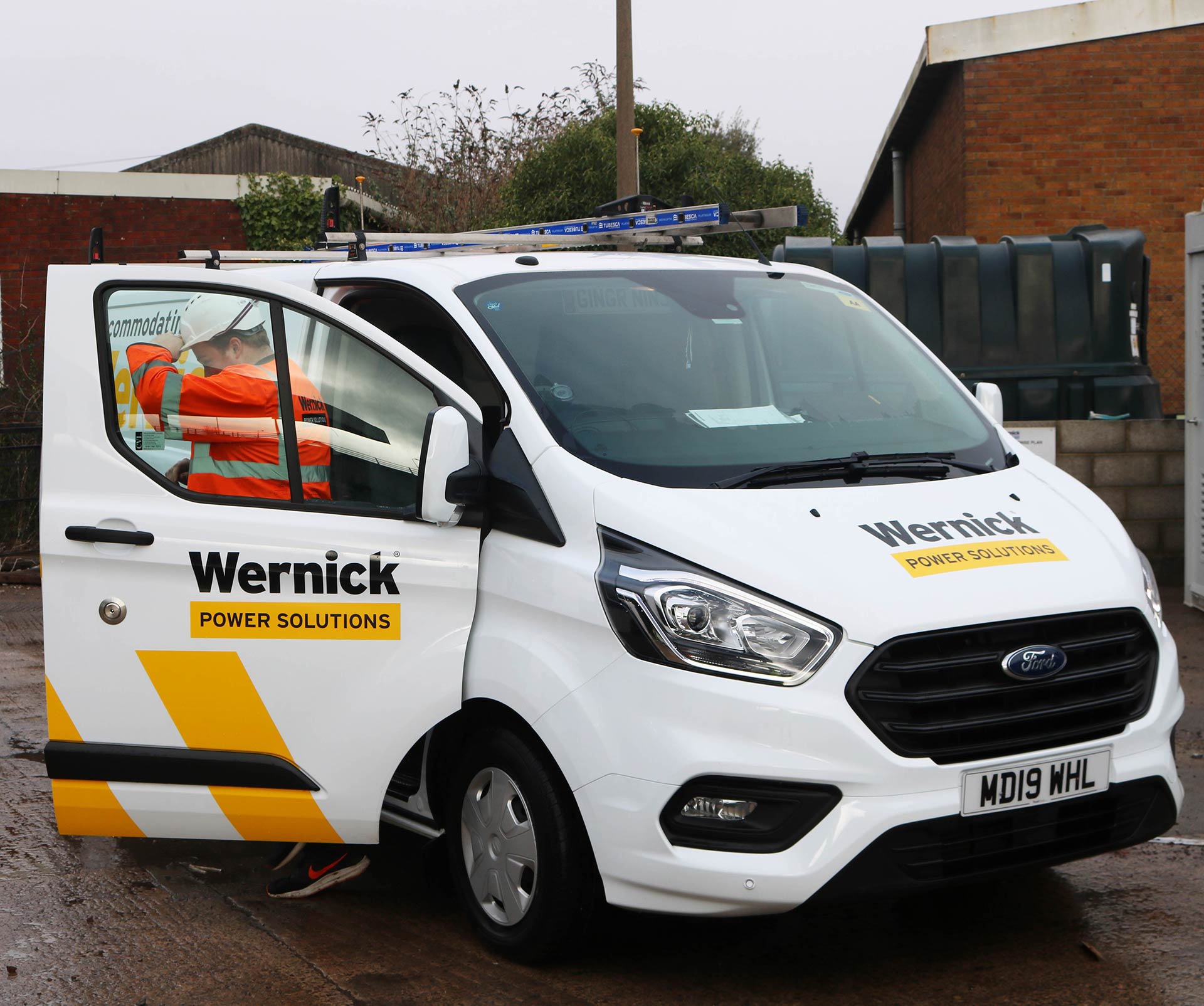 image of employee getting out of a Wernick Power Solutions van.