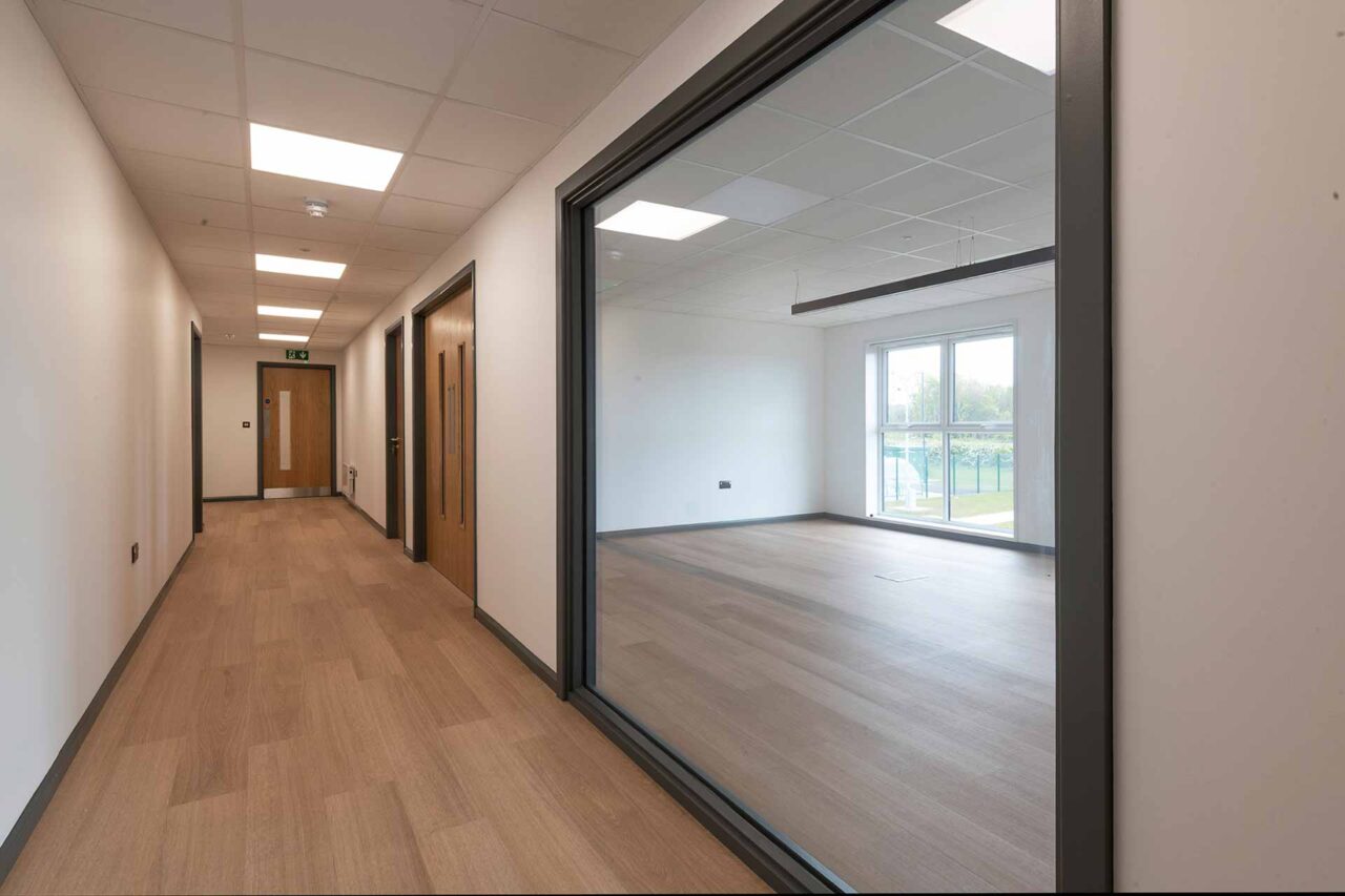 image of hallway with bespoke window fit out of refurbished modular building