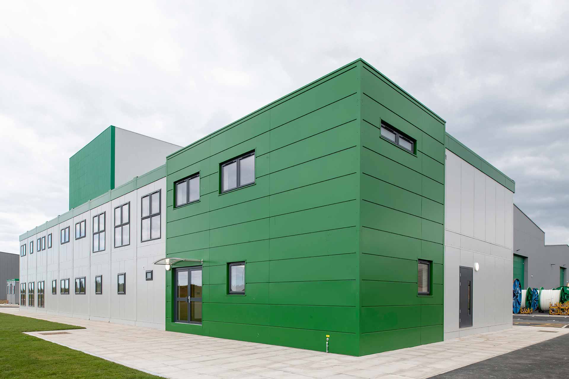 Image of a refurbished modular building with green detailed entrance