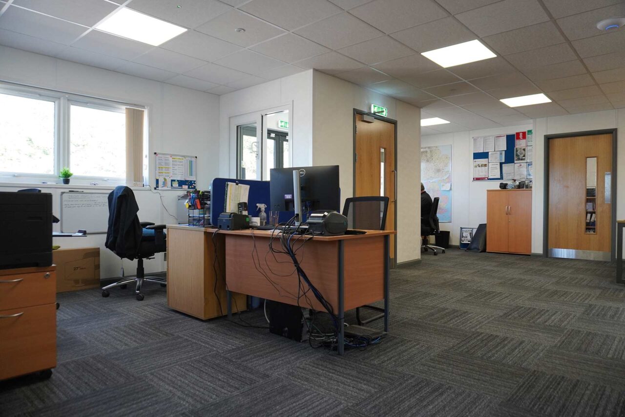 Image of an open plan reception and office area of a refurbished modular building